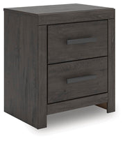 Ashley Furniture Prendonea nightstand with a modern design, featuring a drawer and open shelf, shown from a side angle.