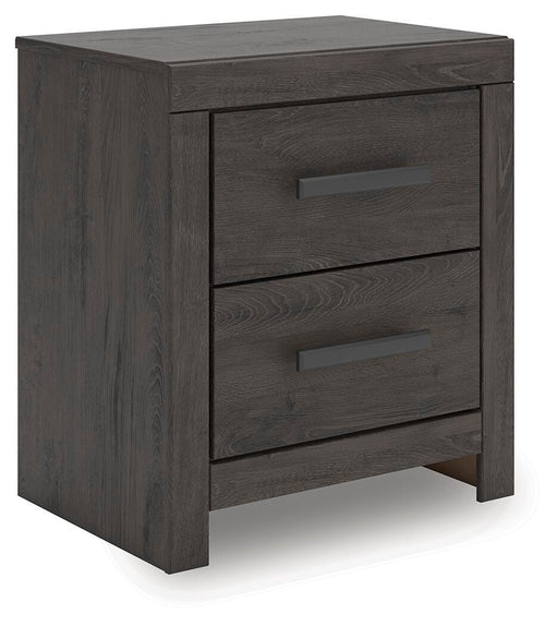 Ashley Furniture Prendonea nightstand with a modern design, featuring a drawer and open shelf, shown from a side angle.