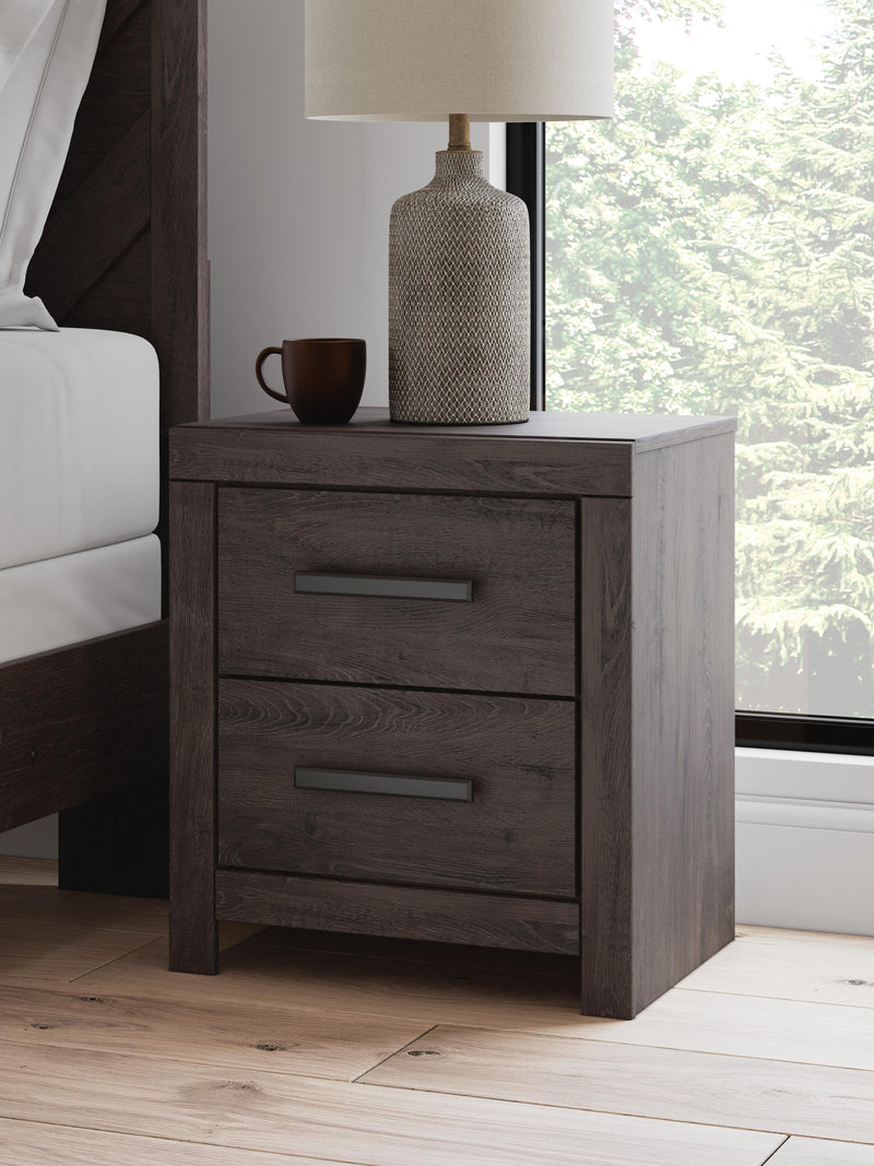 Ashley Furniture Prendonea nightstand with a dark wood finish, featuring a drawer and open shelf for bedroom storage.
