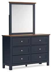Ashley Furniture Landocken bedroom set with bed, dresser, and nightstands, shown from an angled view in a modern bedroom.