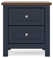 Ashley Furniture Landocken bedroom set with headboard, pillows, and bedding in a cozy bedroom scene.