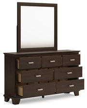 Ashley Furniture Covetown bedroom set including bed frame, nightstands, and dresser, shown from an angled open view.