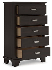 Ashley Furniture Covetown chest of drawers, angled open view showing wooden finish and spacious drawers.