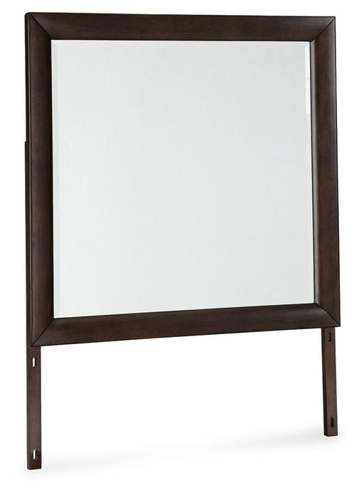 Angle view of Ashley Furniture Dantenton bedroom mirror, rectangular mirror with a wooden frame, mounted on a bedroom wall.