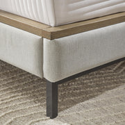 Ashley Furniture Tomtyn upholstered bed with a plush fabric headboard and elegant design, shown in a detailed view.