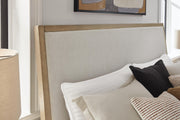 Ashley Furniture Tomtyn upholstered bed with a padded headboard and elegant fabric upholstery, showcasing a stylish bedroom focal point.