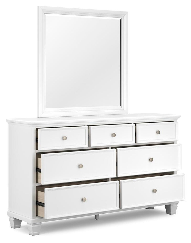 Ashley Furniture Fortman bedroom set with a bed, nightstands, and dresser, shown from an angled view in a modern bedroom.