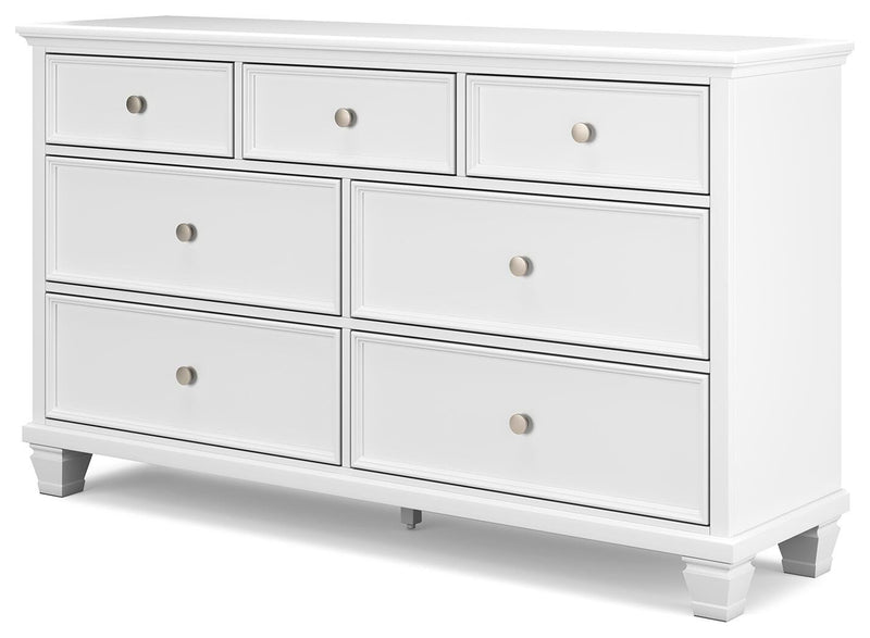 Ashley Furniture Fortman dresser with multiple drawers and sleek wood finish, shown from an angled side view.