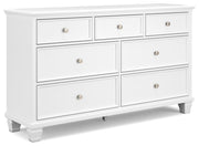Ashley Furniture Fortman dresser with multiple drawers and a sleek wooden finish, shown from an angled side view.