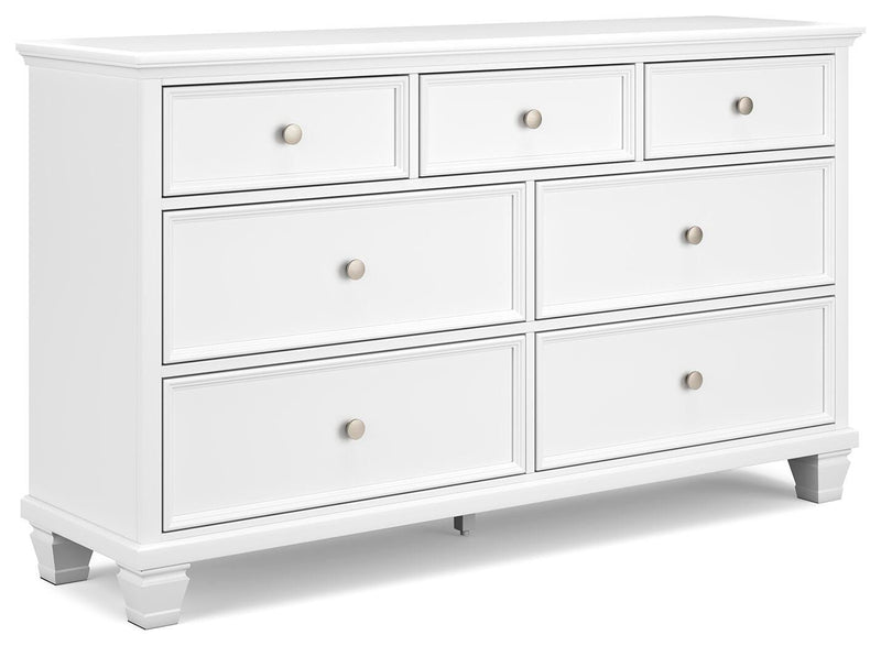 Ashley Furniture Fortman dresser with multiple drawers and a sleek wooden finish, shown from an angled side view.