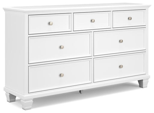 Ashley Furniture Fortman dresser with multiple drawers and a sleek wooden finish, shown from an angled side view.
