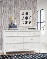 Ashley Furniture Fortman dresser with multiple drawers, dark wood finish, and modern design, ideal for bedroom storage.