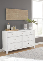 Ashley Furniture Fortman dresser with multiple drawers and a dark wood finish, showcasing a modern bedroom storage solution.