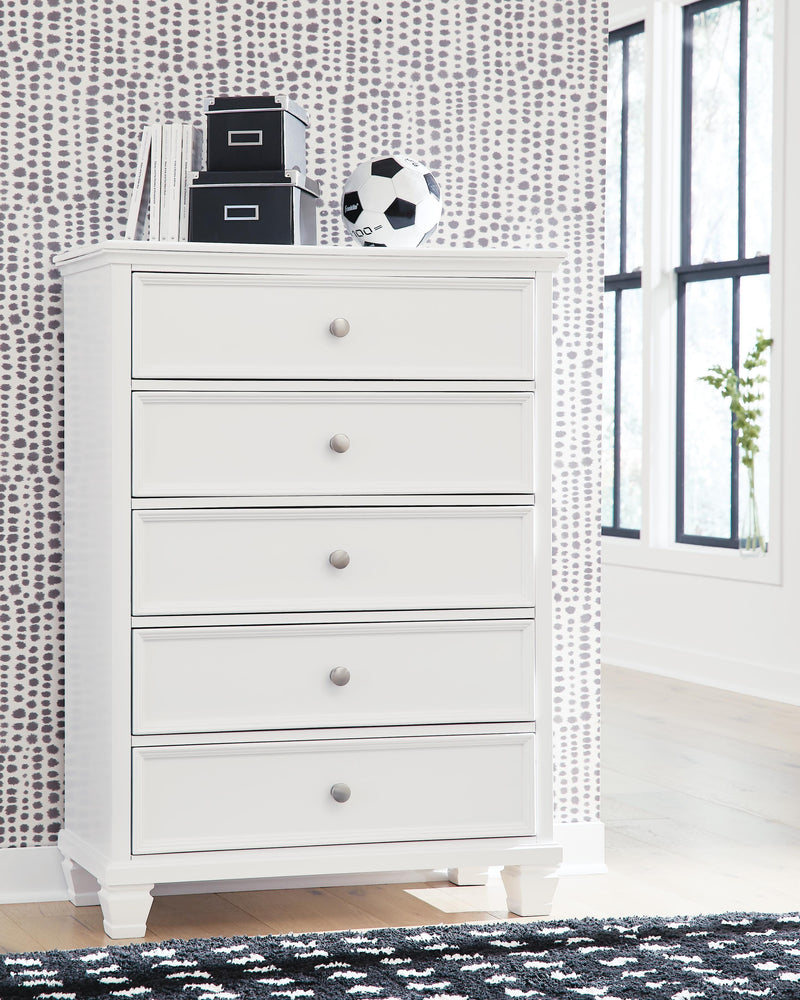 Ashley Furniture Fortman chest of drawers, wooden bedroom storage unit with multiple drawers, in a modern design.