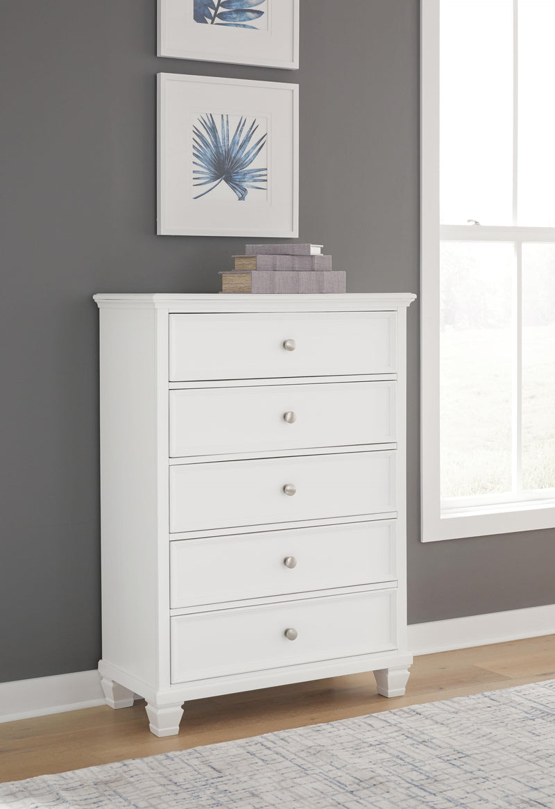 Ashley Furniture Fortman chest of drawers with a sleek wooden finish and multiple storage drawers.