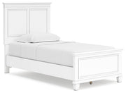 Ashley Furniture Fortman bed with a sturdy wooden frame and classic design, shown from an angled side view.