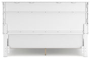 Ashley Furniture Fortman bed with a sturdy wooden frame and classic design, shown from the back in a well-lit bedroom setting.