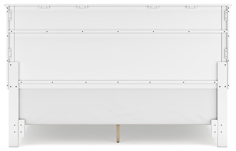 Ashley Furniture Fortman Bed with headboard and wooden frame, shown from the back in a well-lit bedroom setting.