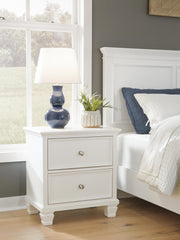 Ashley Furniture Fortman bedroom set with a stylish bed frame, matching nightstands, and a coordinated dresser in a modern bedroom design.
