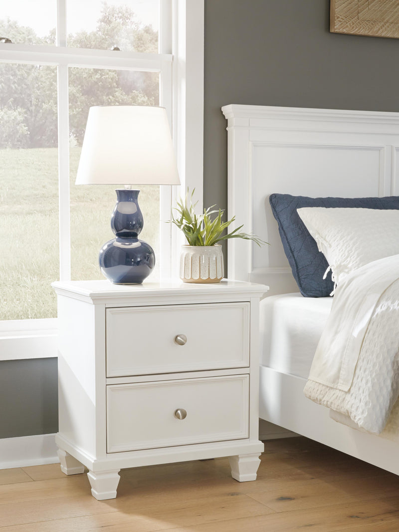 Ashley Furniture Fortman bedroom set with a stylish bed frame, matching nightstands, and a coordinated dresser in a modern bedroom design.
