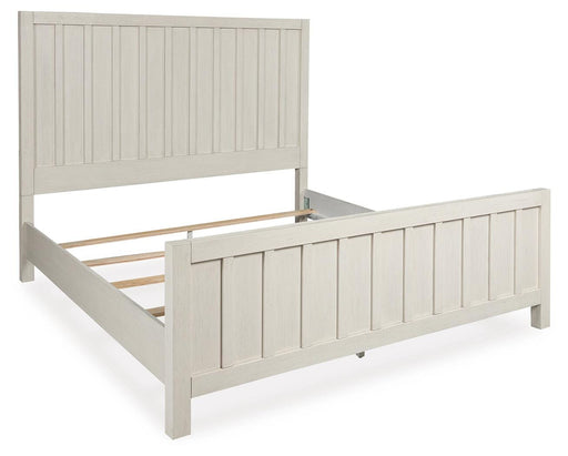 Ashley Furniture Shaybrock Bed in a stylish bedroom setting, showcasing the bed's modern design and wooden finish from an angled view.