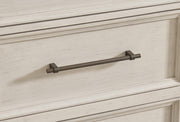 Close-up of Ashley Furniture Shaybrock bedroom set handle detailing, showing sleek hardware on a modern bedroom furniture piece.