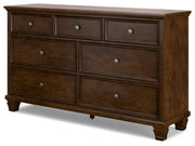 Ashley Furniture Danabrin Dresser with six drawers and modern design, shown in a side-angle view.