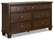 Ashley Furniture Danabrin dresser with six drawers, angled view showing dark wood finish and modern hardware.