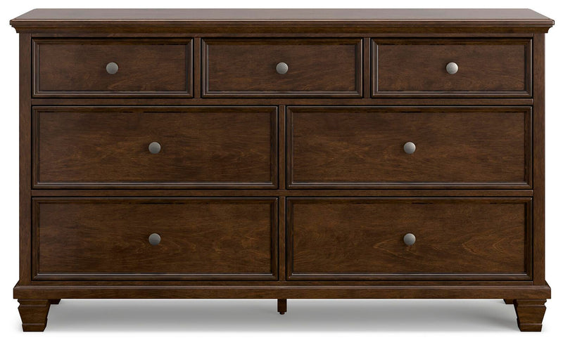 Ashley Furniture Danabrin Dresser with sleek wood finish and multiple drawers, shown head-on in a modern bedroom setting.