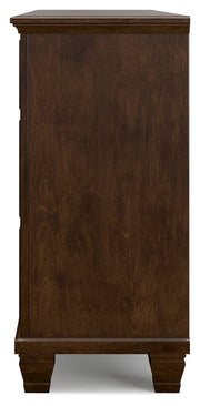 Ashley Furniture Danabrin dresser with sleek wood finish and multiple drawers, shown from a side angle.