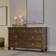 Ashley Furniture Danabrin dresser with multiple drawers, dark wood finish, and modern design for bedroom storage.