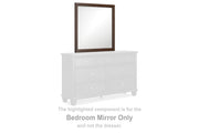 Ashley Furniture Danabrin bedroom mirror with a sleek wood frame, hanging on a wall in a modern bedroom setting.