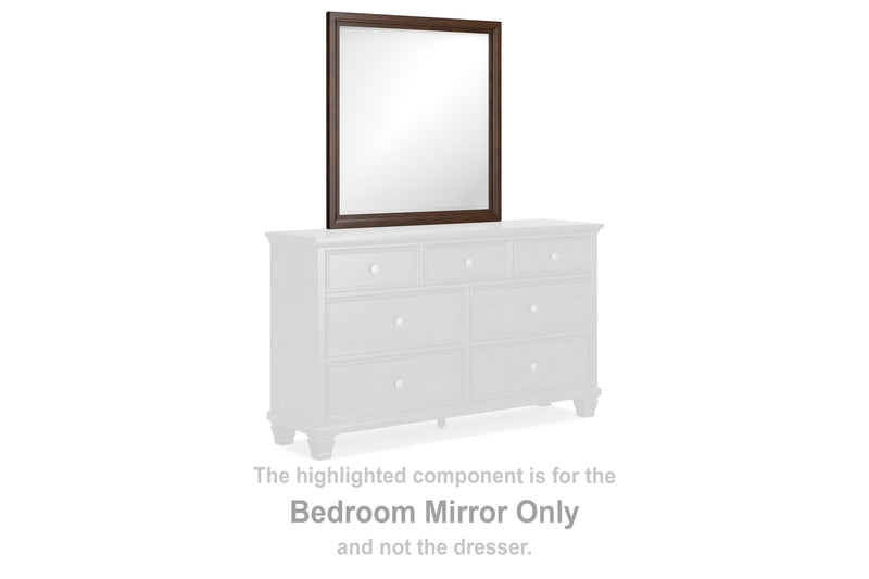 Ashley Furniture Danabrin bedroom mirror with a sleek wood frame, hanging on a wall in a modern bedroom setting.