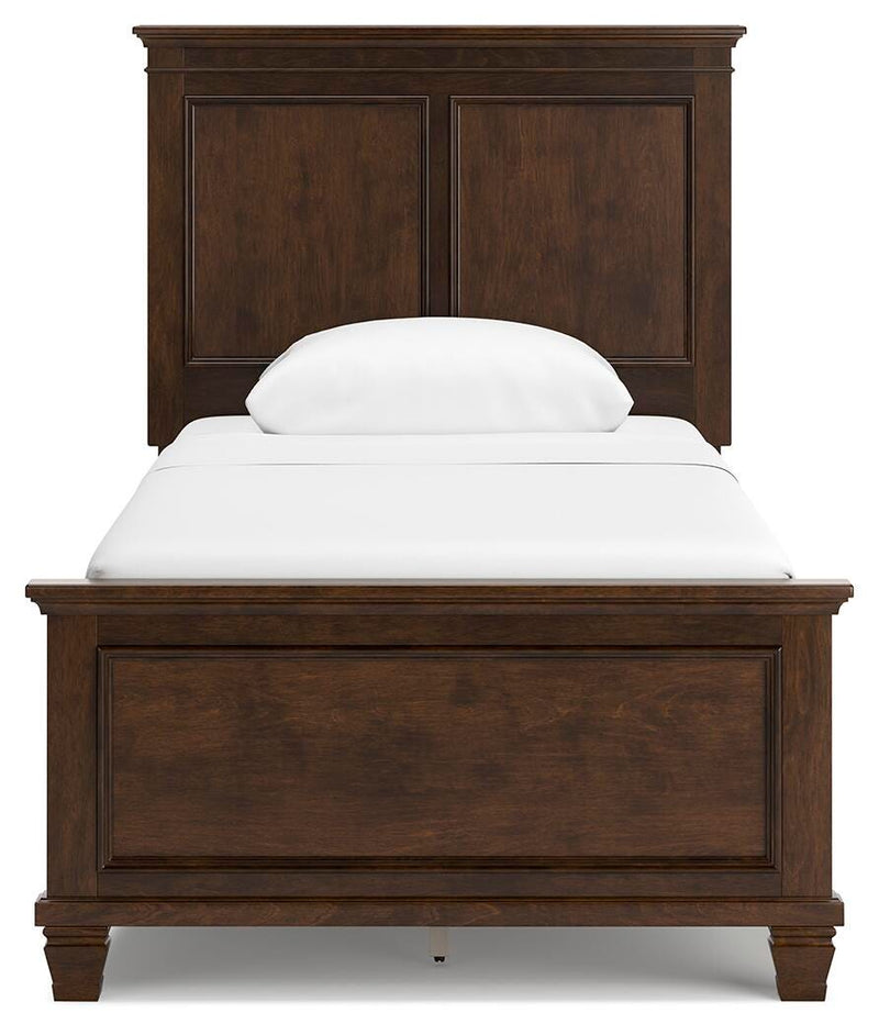 Ashley Furniture Danabrin bed with a stylish headboard, showcasing a modern bedroom design with neutral bedding.