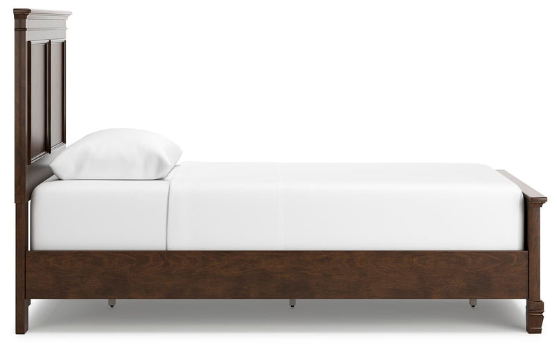 Ashley Furniture Danabrin Bed with side view, showcasing the wooden frame and detailed headboard design.