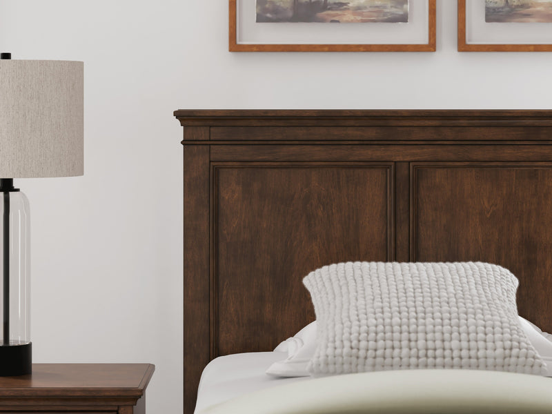 Ashley Furniture Danabrin panel storage bed with a modern design, showcasing the headboard and storage drawers in a bedroom setting.
