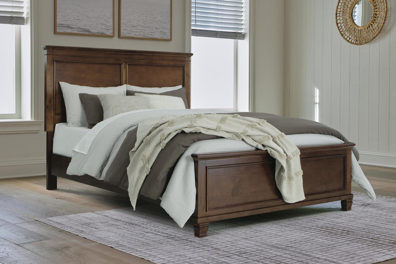 Ashley Furniture Danabrin bed with a modern wooden frame and upholstered headboard, shown in a stylish bedroom setting.
