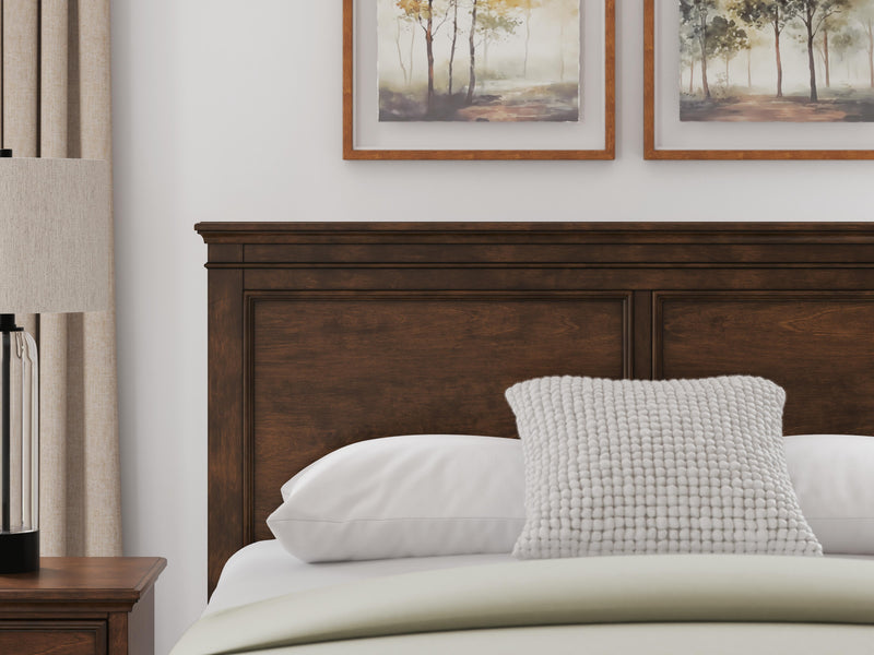 Ashley Furniture Danabrin panel storage bed with built-in storage drawers and a modern wood finish in a bedroom setting.