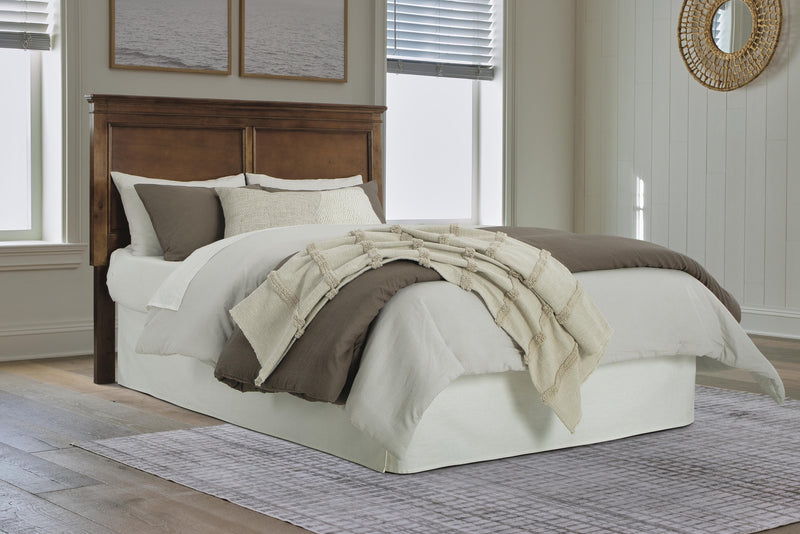 Ashley Furniture Danabrin panel storage bed with wood finish, featuring a headboard, storage drawers, and a sturdy frame.
