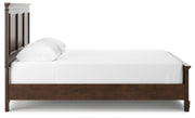 Ashley Furniture Danabrin Bed with a sleek frame and upholstered headboard, shown from a side view.