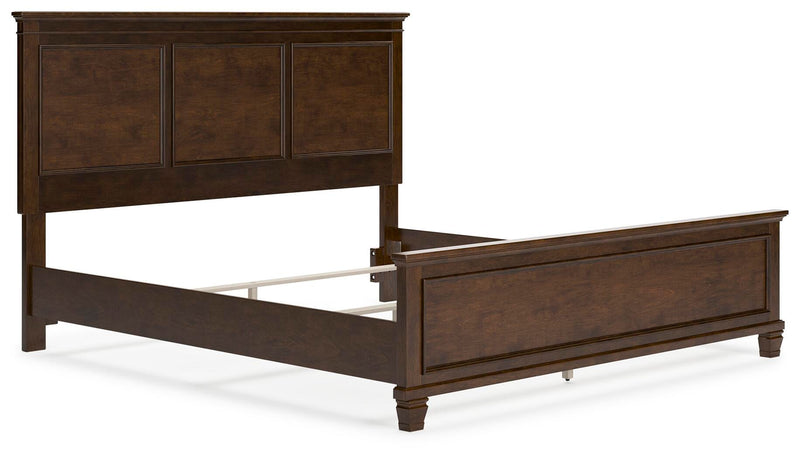 Ashley Furniture Danabrin Bed with upholstered headboard and wooden frame, shown from an angled view.