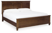 Ashley Furniture Danabrin Bed with a stylish wooden frame and upholstered headboard in a modern bedroom setting.