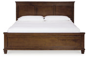 Ashley Furniture Danabrin Bed with a headboard featuring a warm wood finish and classic design.
