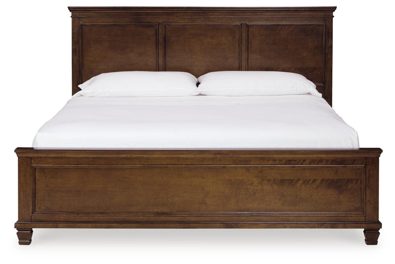 Ashley Furniture Danabrin Bed with a headboard featuring a warm wood finish and classic design.