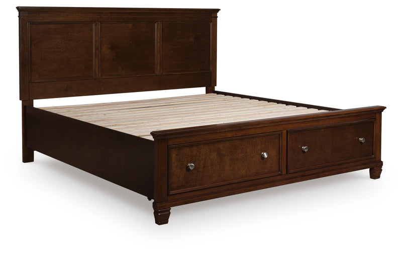 Ashley Furniture Danabrin panel storage bed in dark wood finish, shown from an angled closed view highlighting storage drawers.