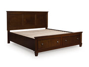 Ashley Furniture Danabrin Panel Storage Bed with closed storage drawers and a sleek, modern design in a neutral finish.