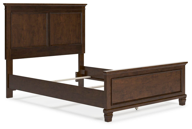 Ashley Furniture Danabrin Bed with a sleek wood finish and modern design, shown from an angled side view.