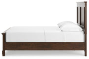 Side view of Ashley Furniture Danabrin Bed showcasing its modern design and wooden finish.