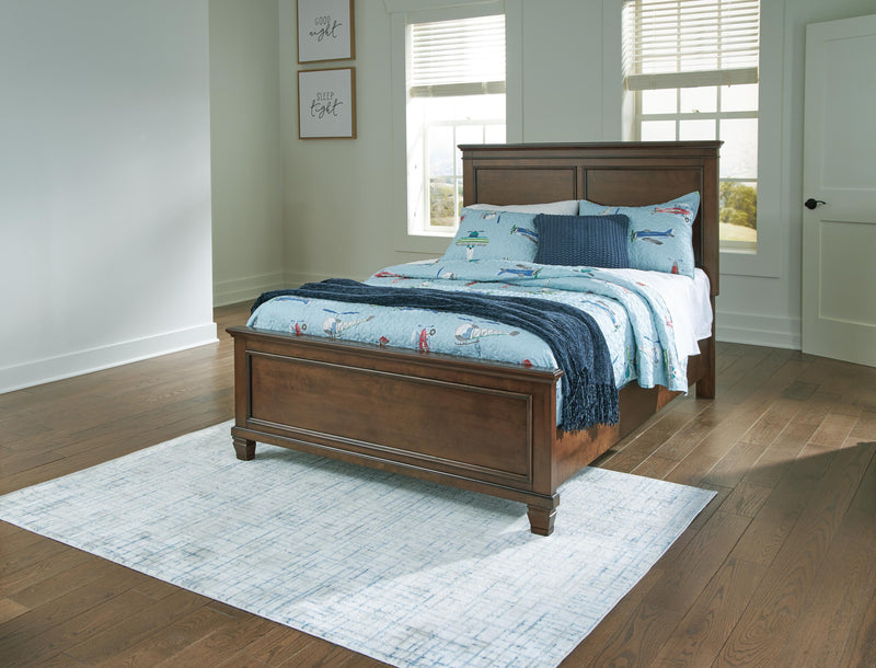 Ashley Furniture Danabrin Bed with a sleek wooden frame and upholstered headboard, showcasing a modern bedroom style.