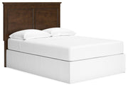 Ashley Furniture Danabrin panel storage bed shown from an angled side view with built-in storage drawers and a modern design.